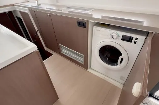 Slide: The Image of 2021 Bali 5.4 interior with built-in washing machine and modern cabinetry. - 12