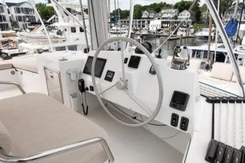 Slide: The Image of Helm of 2021 Bali 5.4 yacht with modern navigation equipment in a marina setting. - 16
