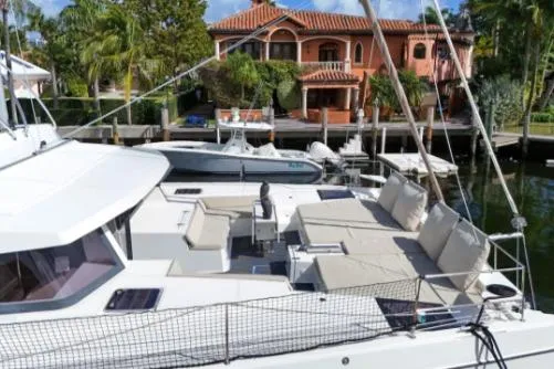 Slide: The Image of 2021 Bali 5.4 yacht docked near a luxurious waterfront villa. - 18