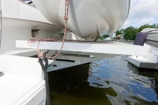 Slide: The Image of 2021 Bali 5.4 yacht with dinghy on davit over water. - 23