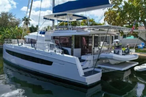 Slide: The Image of 2021 Bali 5.4 catamaran docked, featuring spacious deck and modern design. - 27