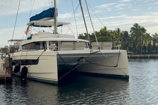 Slide: The Image of 2021 Bali 5.4 catamaran docked in a serene marina setting. - 28
