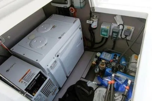 Slide: The Image of Engine compartment of a 2021 Bali 5.4 model, featuring electrical components and storage. - 33