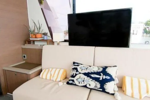 Slide: The Image of Modern yacht interior with cozy sofa, decorative pillows, and a flat-screen TV. Bali 5.4, 2021 model. - 7