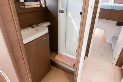 Slide: The Image of 2021 Bali 5.4 yacht bathroom with shower, sink, and wooden cabinetry. - 9