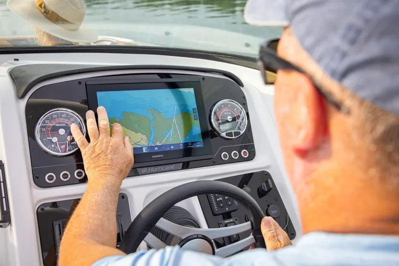 Slide: The Image of Man navigating 2026 Hurricane SunDeck 2690 OB with touchscreen GPS system. - 12