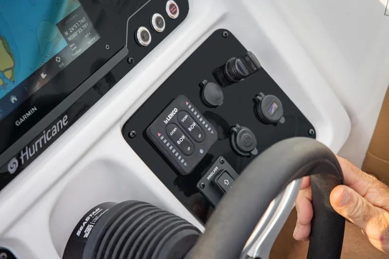 Slide: The Image of 2026 Hurricane SunDeck 2690 OB boat dashboard with steering wheel and control panel. - 13