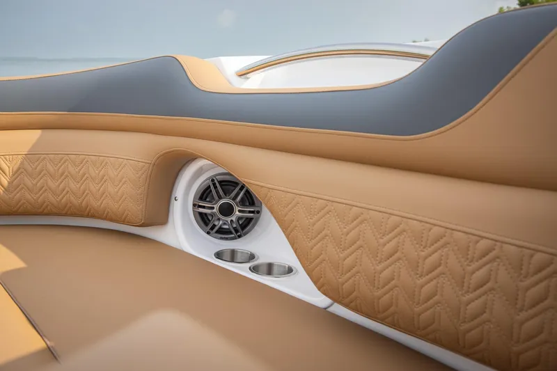 Slide: The Image of Luxurious interior of 2026 Hurricane SunDeck 2690 OB boat with tan upholstery and speaker. - 14