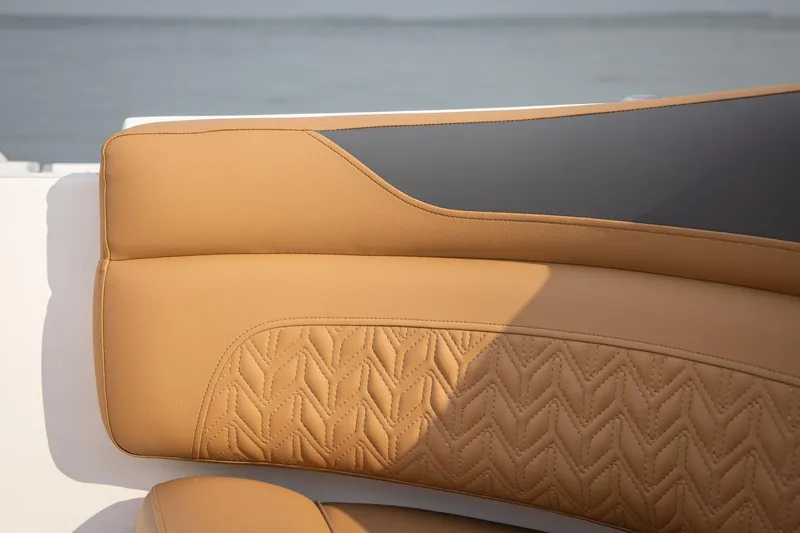 Slide: The Image of Luxurious tan seating on 2026 Hurricane SunDeck 2690 OB boat, featuring intricate stitching. - 15