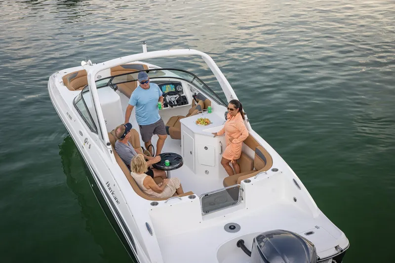 Slide: The Image of 2026 Hurricane SunDeck 2690 OB boat with people enjoying a day on the water. - 16