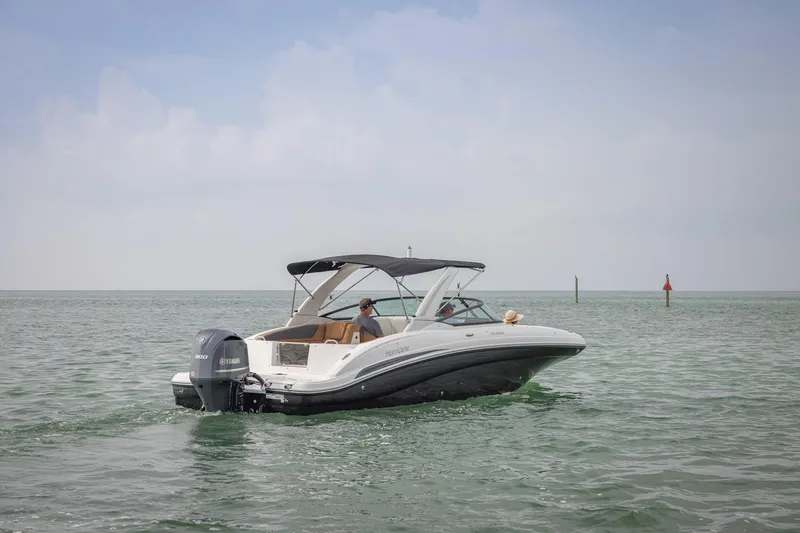 Slide: The Image of 2026 Hurricane SunDeck 2690 OB boat cruising on calm waters under a clear sky. - 19