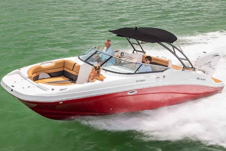 Slide: The Image of Manufacturer Provided Image: 2026 Hurricane SunDeck 2690 OB boat cruising on green water with passengers. - 2