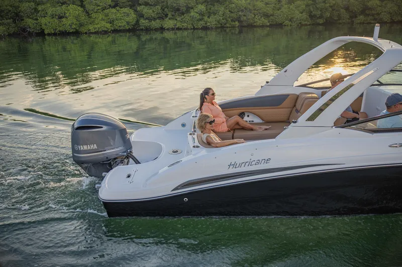 Slide: The Image of 2026 Hurricane SunDeck 2690 OB cruising on a serene waterway with passengers relaxing. - 22