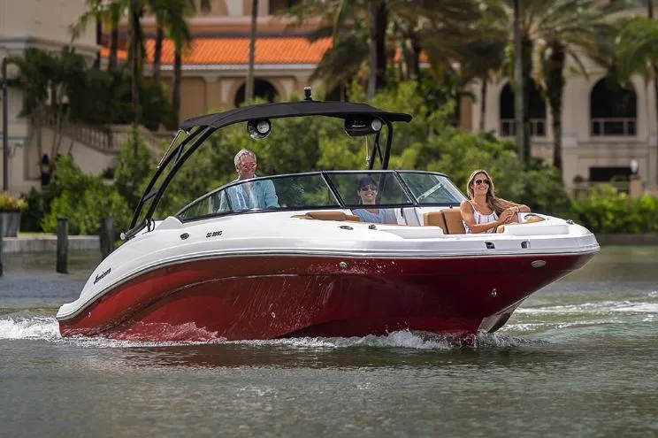 Slide: The Image of Manufacturer Provided Image: 2026 Hurricane SunDeck 2690 OB cruising on water with passengers, surrounded by lush greenery. - 3