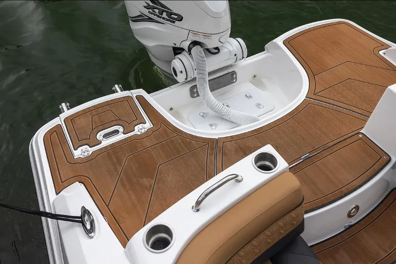 Slide: The Image of Manufacturer Provided Image: 2026 Hurricane SunDeck 2690 OB boat deck with teak flooring and outboard motor. - 4
