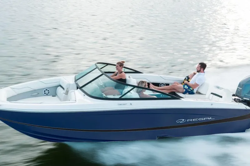 Slide: The Image of 2026 Regal LX2 boat cruising on water with passengers enjoying the ride. - 14