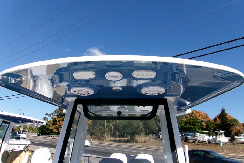 Slide: The Image of 2025 Sportsman Open 252 Center Console boat with sleek T-top design under clear blue sky. - 10