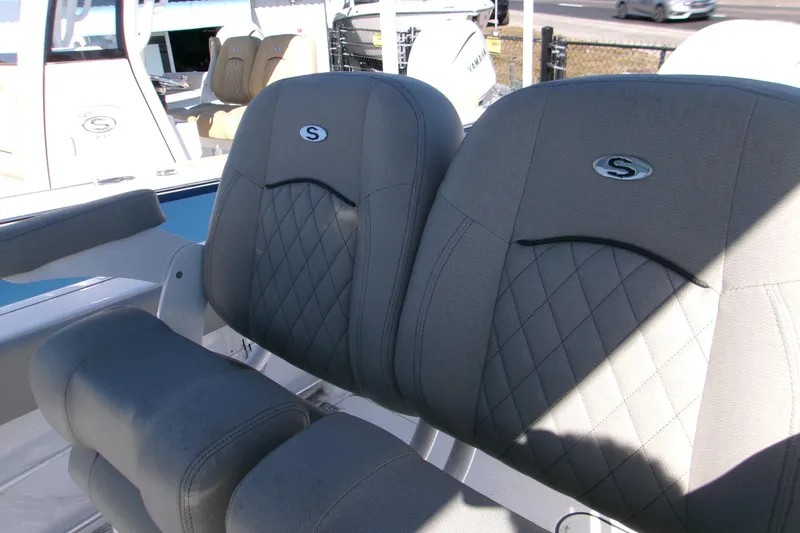Slide: The Image of 2025 Sportsman Open 252 Center Console boat seats with diamond stitching and logo. - 12