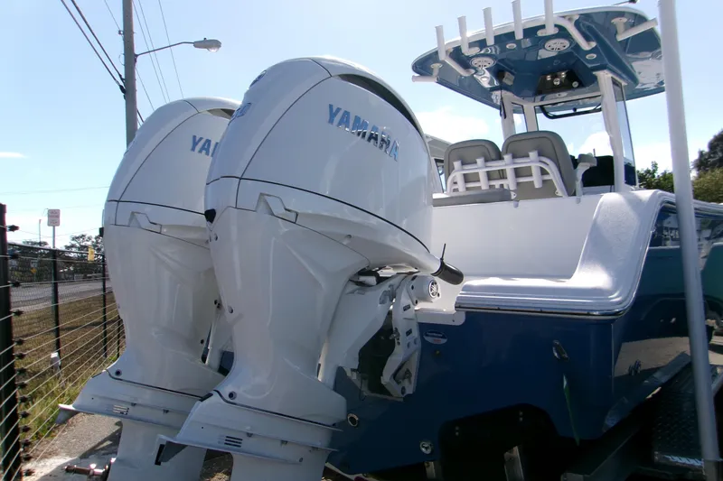 Slide: The Image of 2025 Sportsman Open 252 Center Console boat with dual Yamaha outboard engines. - 16