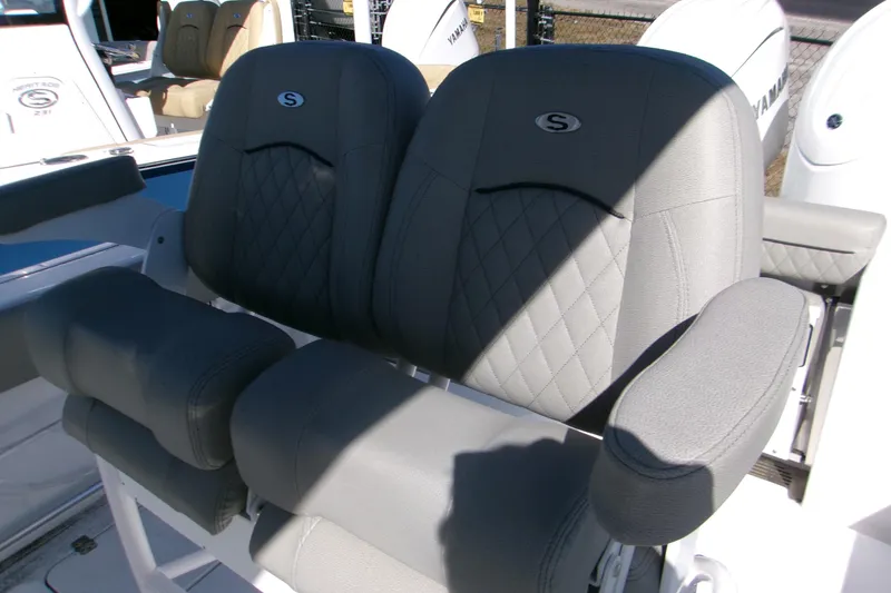 Slide: The Image of 2025 Sportsman Open 252 Center Console boat seats with gray upholstery and armrests. - 5