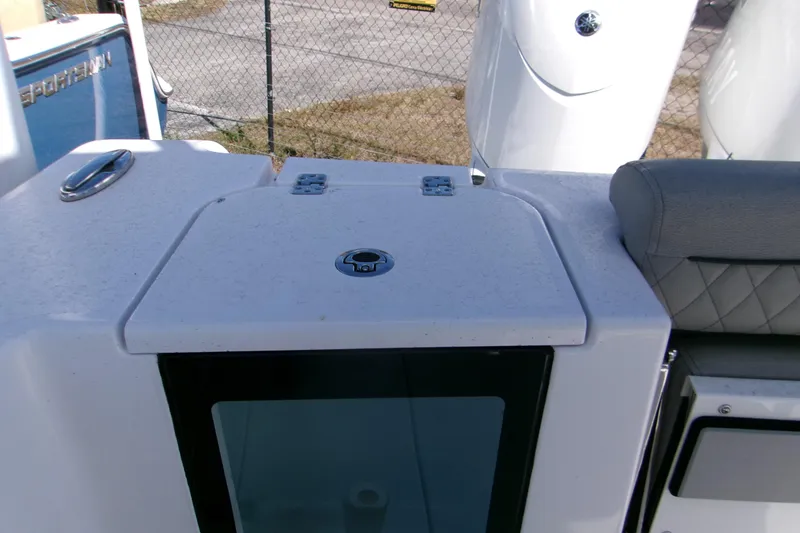 Slide: The Image of 2025 Sportsman Open 252 Center Console boat interior, featuring storage compartment and seating. - 7