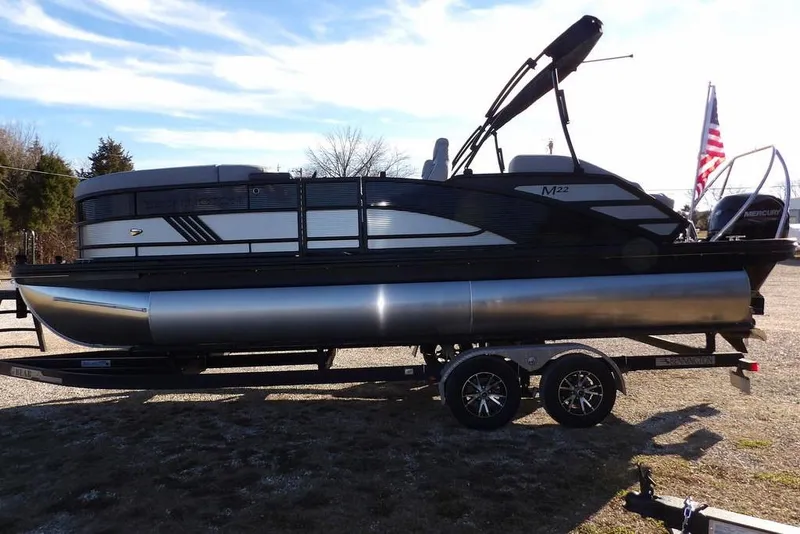Slide: The Image of 2026 Bennington M Swingback 22 MSB pontoon boat on trailer, side view. - 10
