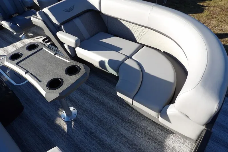 Slide: The Image of 2026 Bennington M Swingback 22 MSB interior with plush seating and cupholder table. - 14