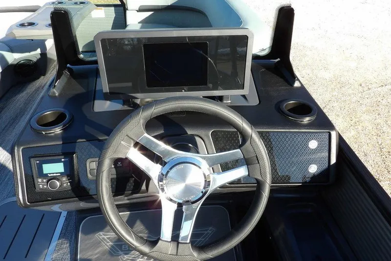 Slide: The Image of 2026 Bennington M Swingback 22 MSB boat dashboard with steering wheel and touchscreen display. - 17
