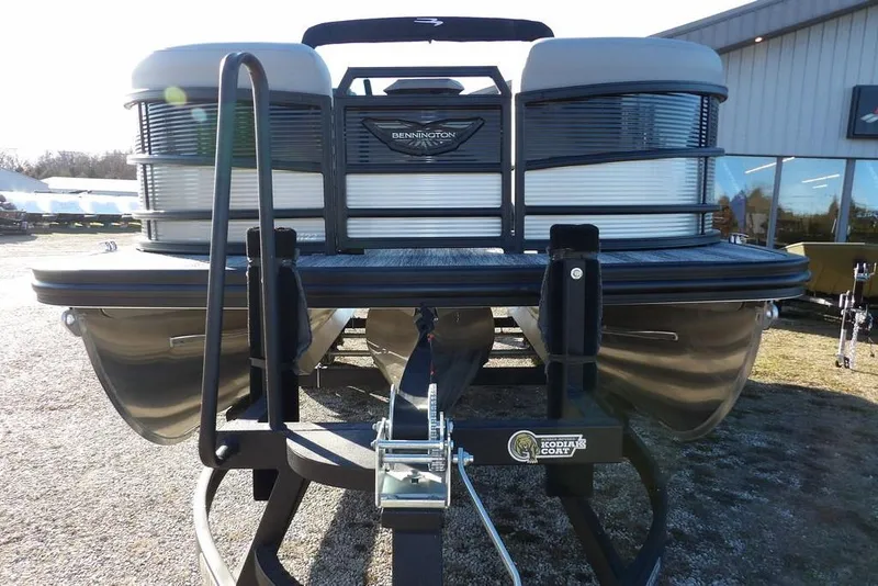 Slide: The Image of 2026 Bennington M Swingback 22 MSB pontoon boat on trailer, front view. - 2