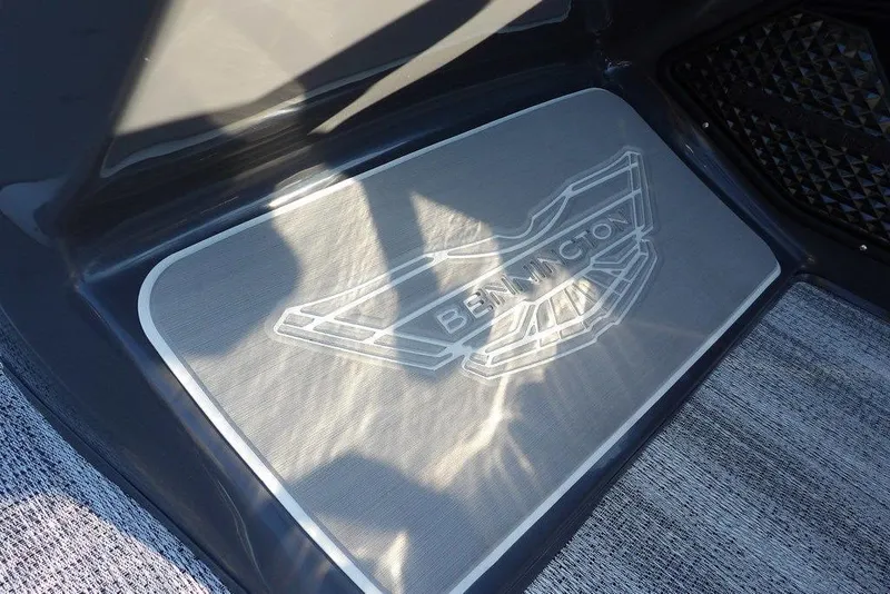 Slide: The Image of Bennington M Swingback 22 MSB 2026 logo on boat floor mat, illuminated by sunlight. - 26