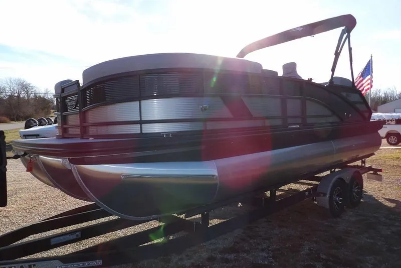 Slide: The Image of 2026 Bennington M Swingback 22 MSB pontoon boat on trailer, sunny day. - 4