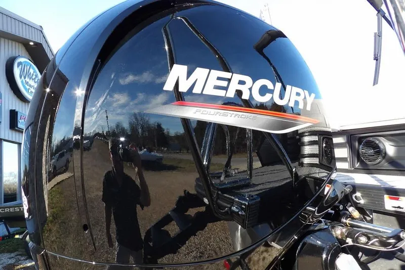 Slide: The Image of Mercury FourStroke engine on 2026 Bennington M Swingback 22 MSB boat, reflecting surroundings. - 42