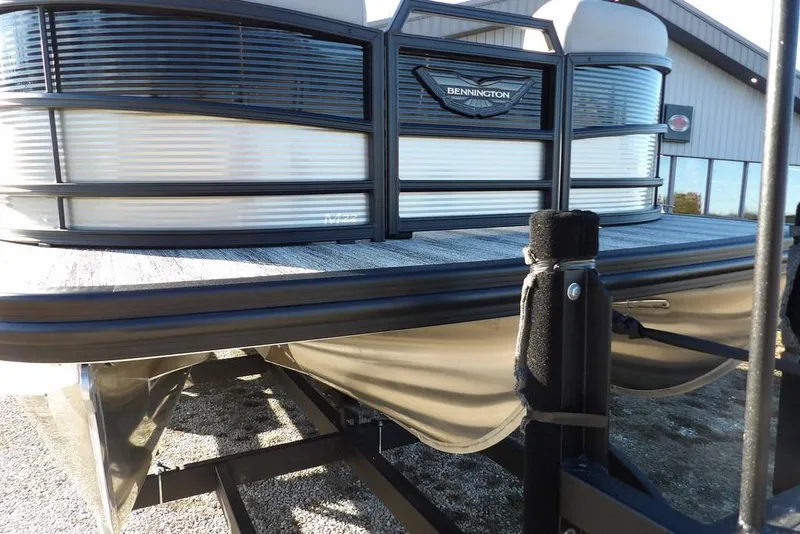 Slide: The Image of 2026 Bennington M Swingback 22 MSB pontoon boat on trailer, outdoor setting. - 45