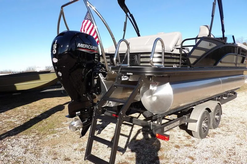 Slide: The Image of 2026 Bennington M Swingback 22 MSB pontoon boat with Mercury 150 engine and American flag. - 46