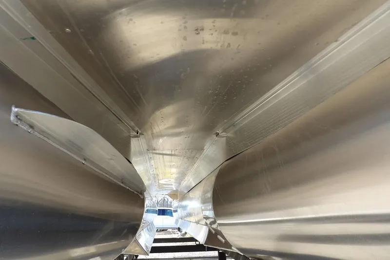 Slide: The Image of Underneath view of 2026 Bennington M Swingback 22 MSB pontoon boat, showcasing sleek aluminum construction. - 49