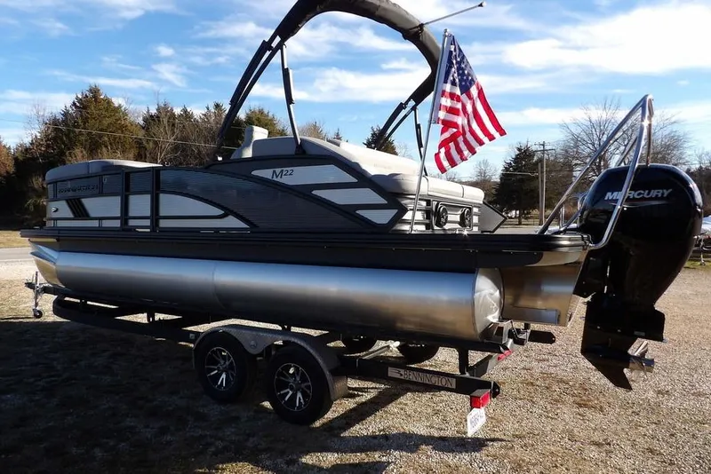 Slide: The Image of 2026 Bennington M Swingback 22 MSB pontoon boat with Mercury engine and American flag. - 9
