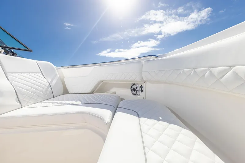 Slide: The Image of Manufacturer Provided Image: Luxurious seating on 2025 Pursuit DC 306 Dual Console boat under sunny sky. - 9