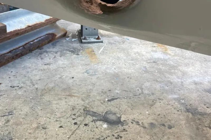 Slide: The Image of Rusty metal surface under a 2021 Nimbus T8 boat, showing wear and corrosion. - 14