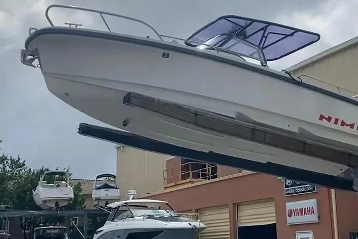 Slide: The Image of 2021 Nimbus T8 boat with covered seating, docked by wooden piers. - 20