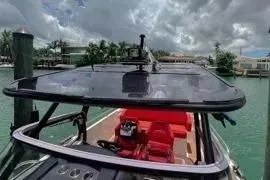 Slide: The Image of 2021 Nimbus T8 boat with sleek design, docked near modern buildings. - 28