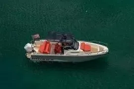 Slide: The Image of Aerial view of 2021 Nimbus T8 boat with red seating on green water. - 3