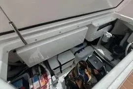 Slide: The Image of Open storage compartment on 2021 Nimbus T8 boat deck with visible equipment. - 33