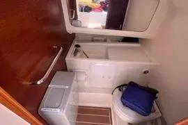 Slide: The Image of Red seating and wooden table on 2021 Nimbus T8 boat deck. - 41