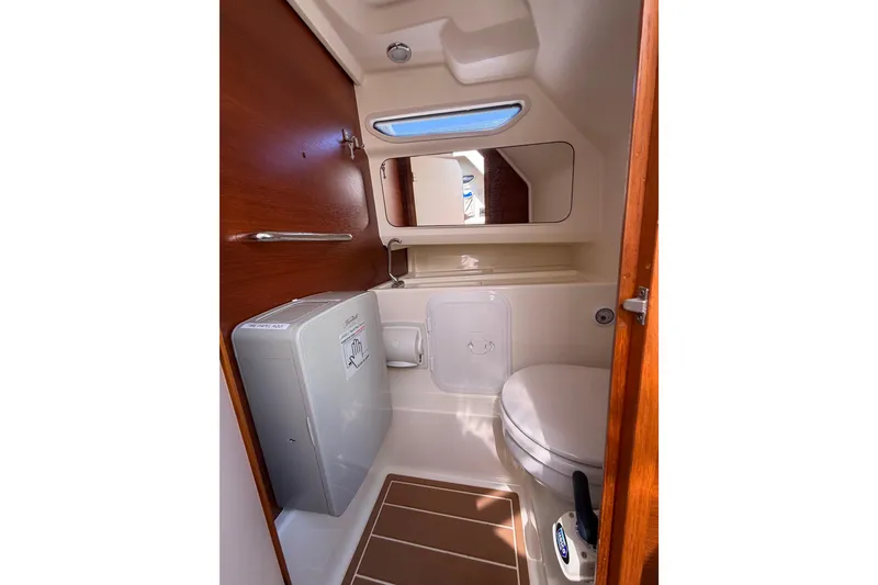 Slide: The Image of Compact bathroom in 2021 Nimbus T8 boat with wooden accents and modern fixtures. - 48