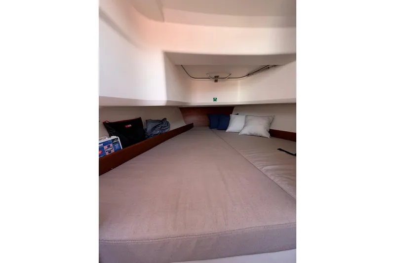 Slide: The Image of Cozy cabin interior of 2021 Nimbus T8 boat with cushions and storage. - 49