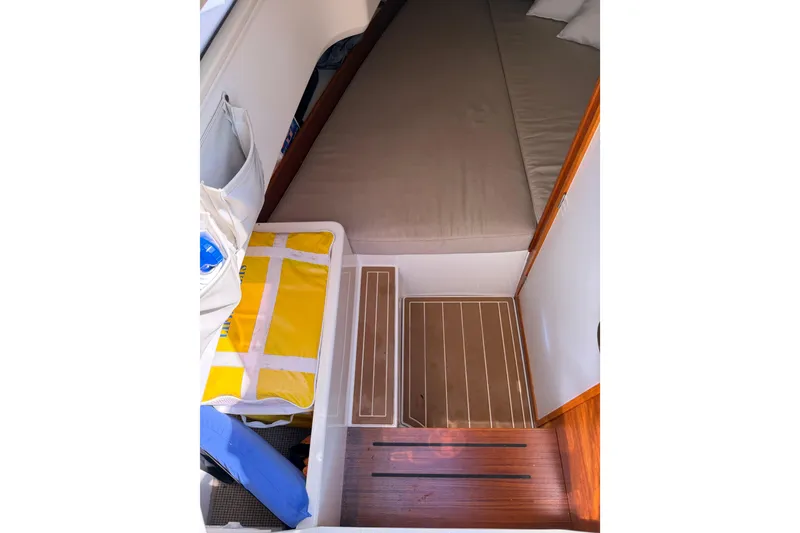 Slide: The Image of Interior cabin of 2021 Nimbus T8 boat with bed and storage area. - 51