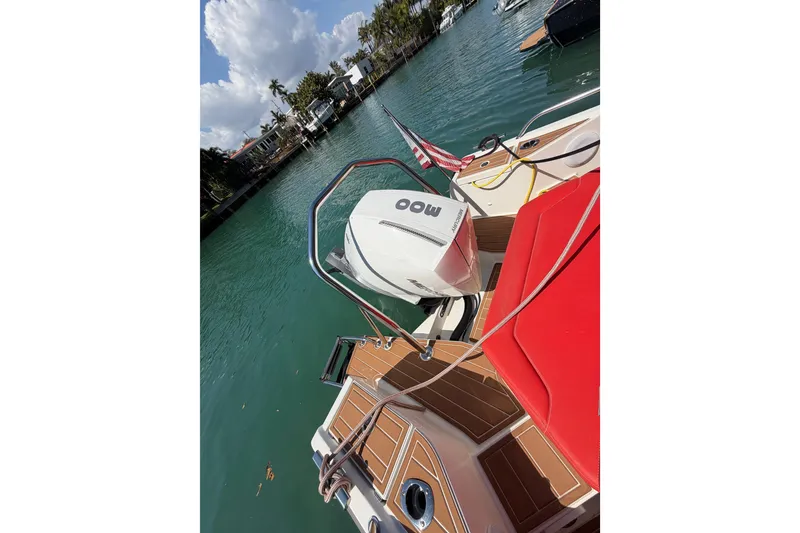 Slide: The Image of 2021 Nimbus T8 boat with outboard motor, docked on a sunny day. - 55