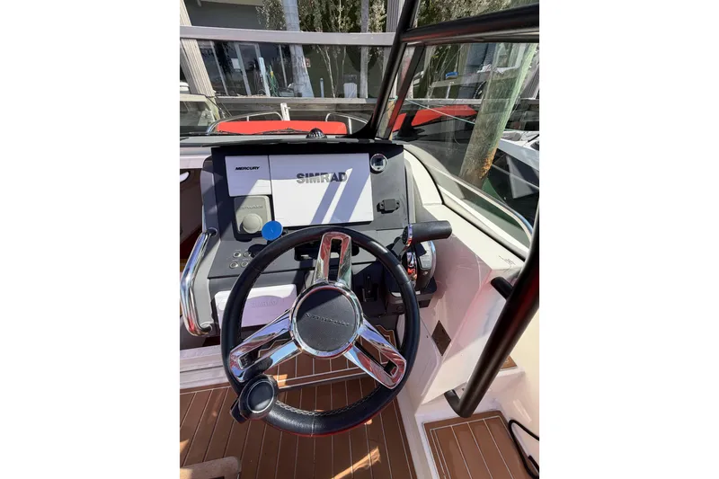 Slide: The Image of Steering wheel and dashboard of 2021 Nimbus T8 boat with Simrad display. - 57