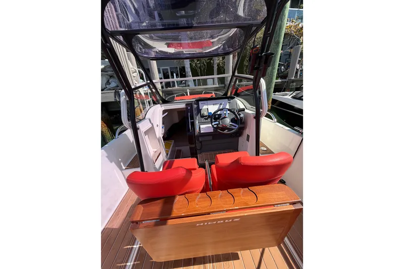 Slide: The Image of 2021 Nimbus T8 boat interior with red seats and modern dashboard. - 58