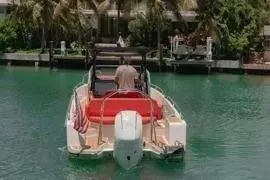 Slide: The Image of 2021 Nimbus T8 boat cruising on a serene waterway with lush greenery. - 6